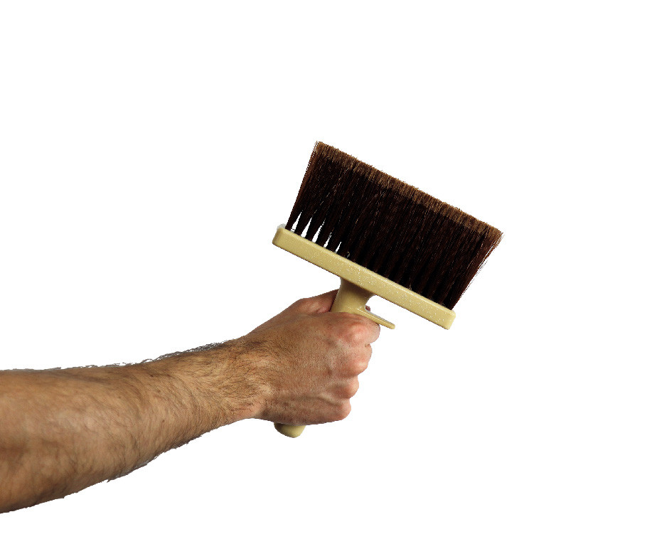 Une personne tenant la brosse rectangulaire monobloc